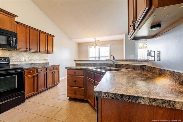 kitchen featuring light tile patterned floors, dark countertops, lofted ceiling, a sink, and black appliances