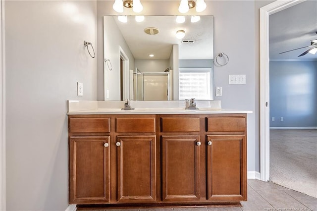 bathroom with a shower stall, visible vents, ceiling fan, and a sink