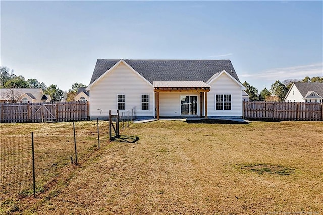 back of property with a lawn and a fenced backyard