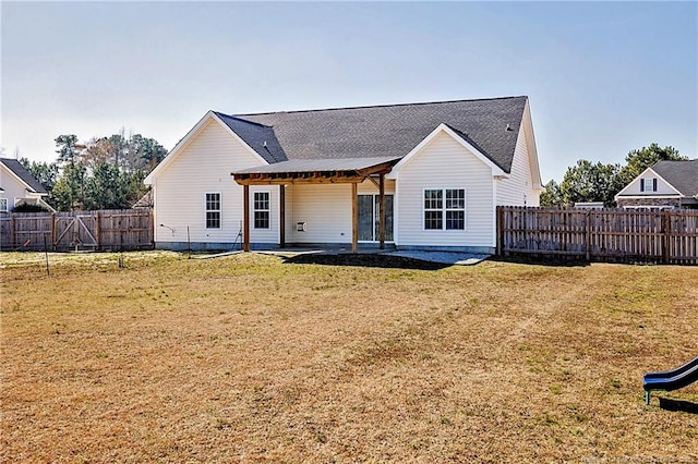 back of house featuring a fenced backyard, a lawn, and a patio