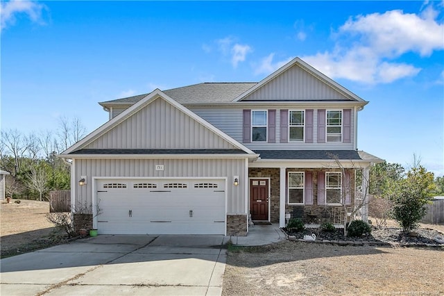 craftsman-style home with an attached garage, covered porch, driveway, stone siding, and board and batten siding