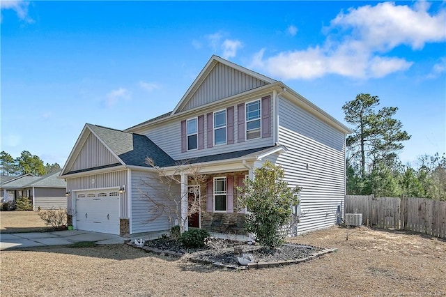 view of front of house with a garage, fence, concrete driveway, roof with shingles, and board and batten siding