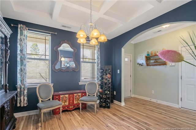 interior space with baseboards, visible vents, arched walkways, coffered ceiling, and wood finished floors