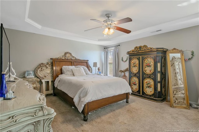 bedroom with carpet, ceiling fan, visible vents, and a raised ceiling