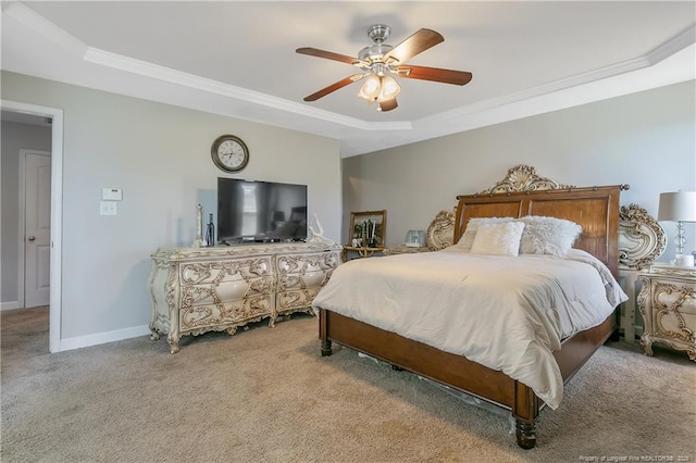 carpeted bedroom with ornamental molding, a raised ceiling, ceiling fan, and baseboards