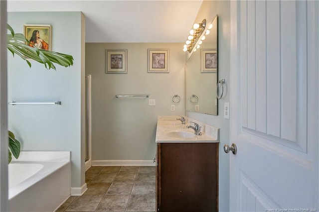 bathroom with double vanity, baseboards, tile patterned floors, a garden tub, and walk in shower