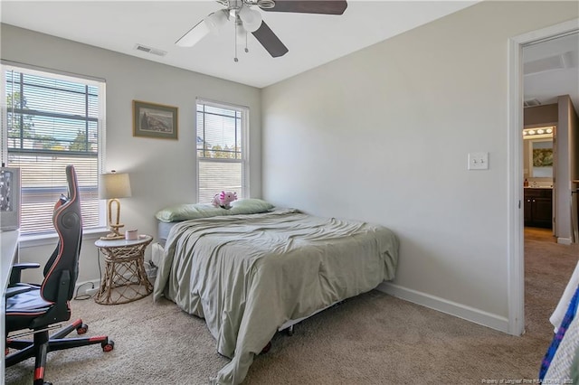 carpeted bedroom with visible vents, baseboards, and a ceiling fan