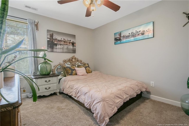 bedroom featuring ceiling fan, carpet, visible vents, and baseboards