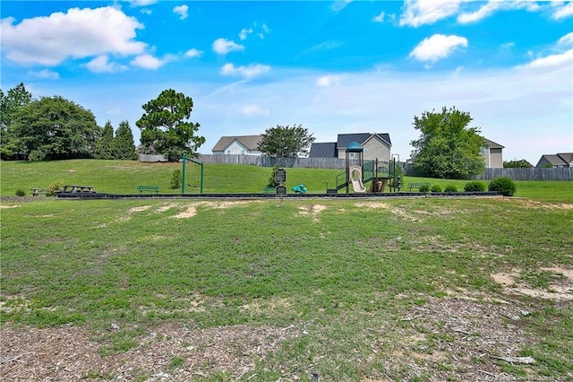 view of yard featuring a playground and fence