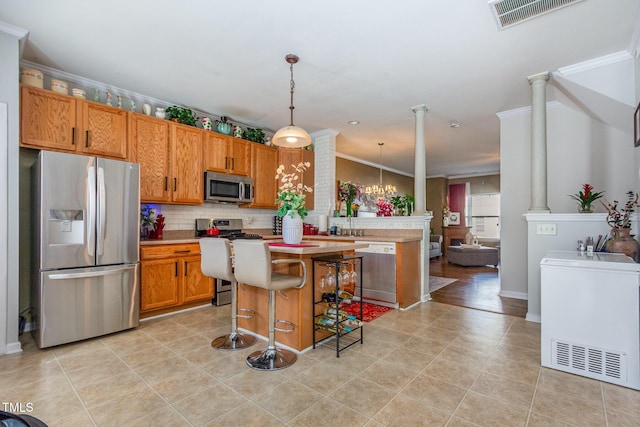 11843 Canemount St, Raleigh, NC 27614 - kitchen featuring appliances with stainless steel finishes, visible vents, and decorative columns