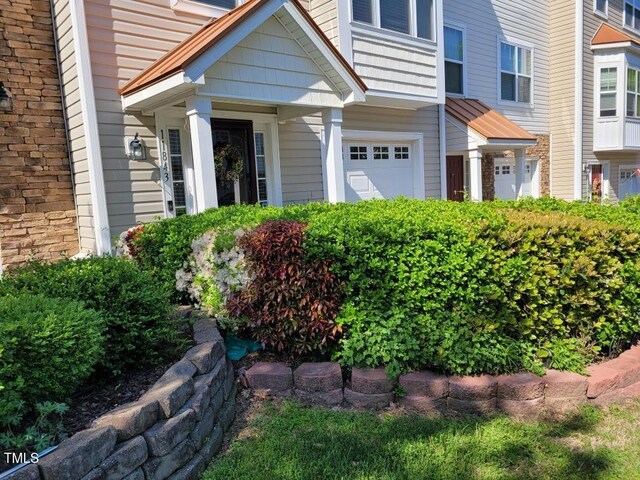 11843 Canemount St, Raleigh, NC 27614 - view of exterior entry featuring a garage