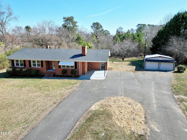 ranch-style home featuring an outbuilding, brick siding, a chimney, a garage, and a front lawn