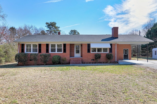 single story home featuring driveway, a chimney, an attached carport, a front lawn, and brick siding