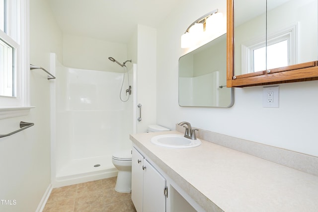 bathroom featuring toilet, tile patterned flooring, a shower, and vanity