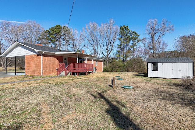 view of yard featuring a carport, an outbuilding, a wooden deck, and a storage shed