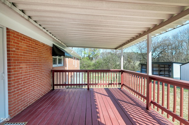 wooden deck featuring an outbuilding