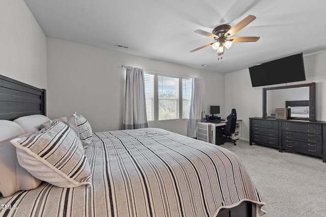 carpeted bedroom with ceiling fan and visible vents