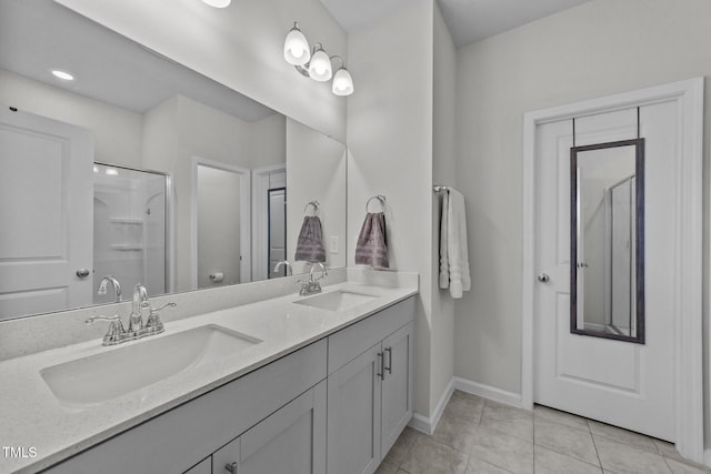 full bath featuring double vanity, tile patterned flooring, a sink, and a shower with shower door