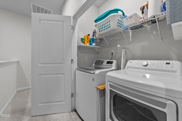 laundry room with light carpet, laundry area, visible vents, baseboards, and independent washer and dryer