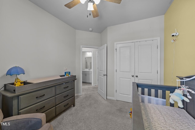 bedroom featuring a ceiling fan, a closet, light colored carpet, and baseboards