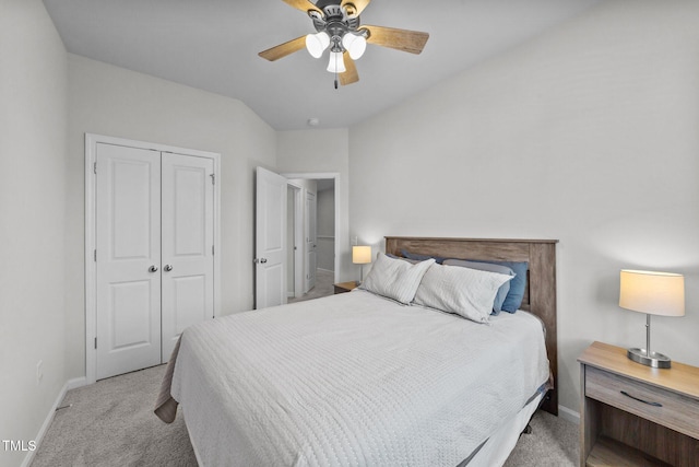 bedroom with ceiling fan, baseboards, a closet, and light colored carpet