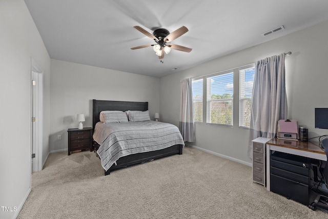 bedroom with a ceiling fan, light colored carpet, visible vents, and baseboards