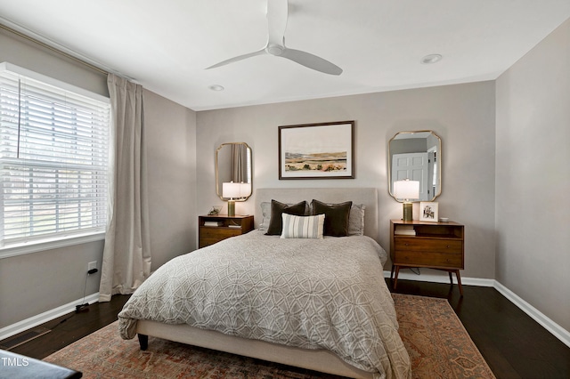 bedroom featuring ceiling fan, baseboards, and wood finished floors