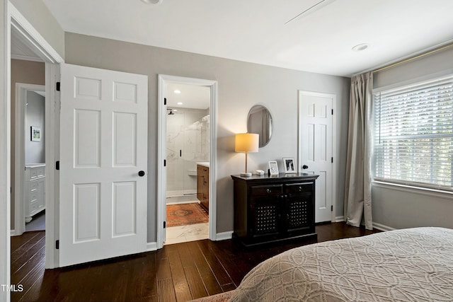 bedroom with wood finished floors, baseboards, and connected bathroom