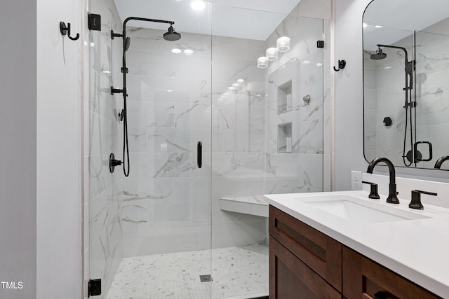 full bathroom with a shower stall and vanity