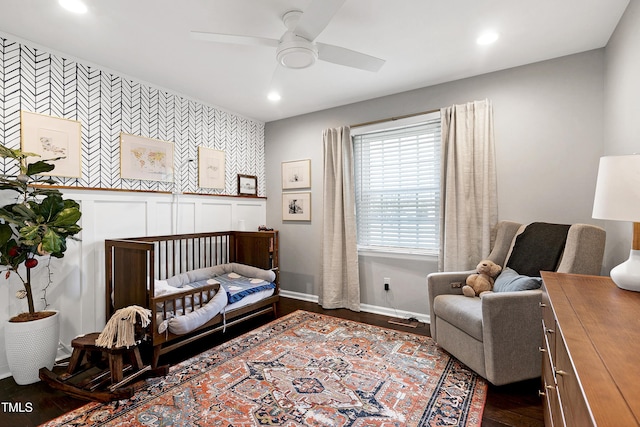 bedroom with recessed lighting, baseboards, an accent wall, and dark wood-type flooring