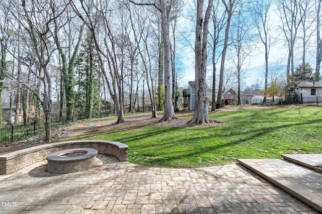 view of patio featuring a fire pit and fence