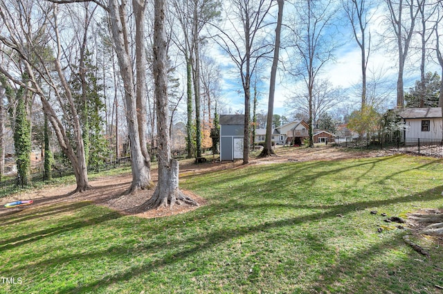 view of yard featuring an outbuilding and fence