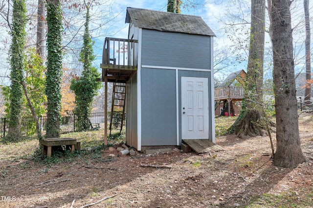 view of shed featuring fence