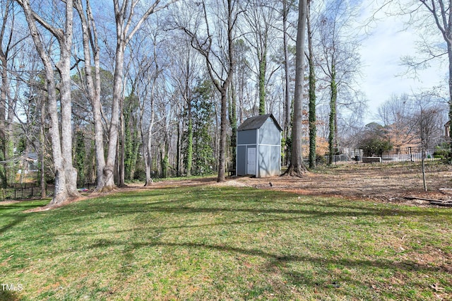 view of yard featuring an outbuilding, fence, and a barn