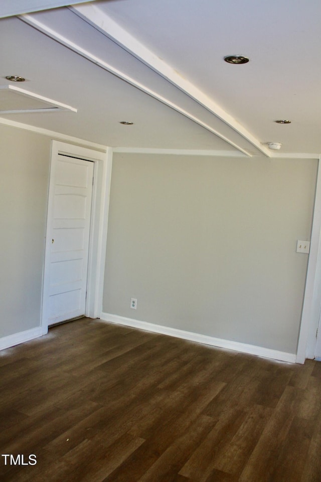 unfurnished room featuring dark wood-style flooring and baseboards