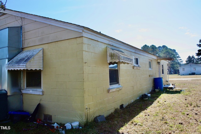 view of side of property featuring concrete block siding