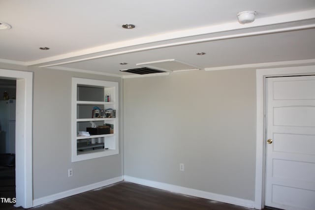 unfurnished room with built in shelves, recessed lighting, visible vents, dark wood-type flooring, and baseboards