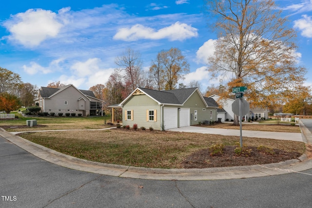 ranch-style house featuring a garage, driveway, a front lawn, and board and batten siding