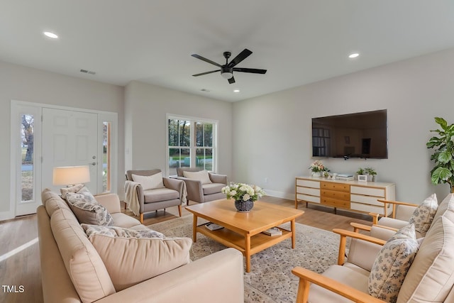 living room featuring recessed lighting, wood finished floors, visible vents, baseboards, and a ceiling fan