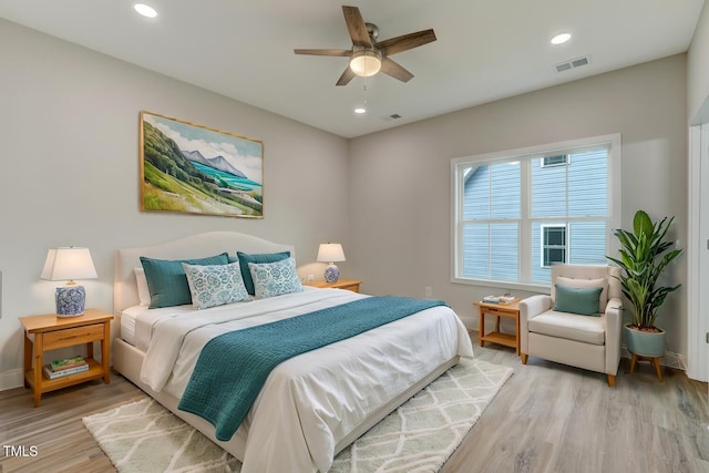 bedroom with light wood-style floors, visible vents, and recessed lighting