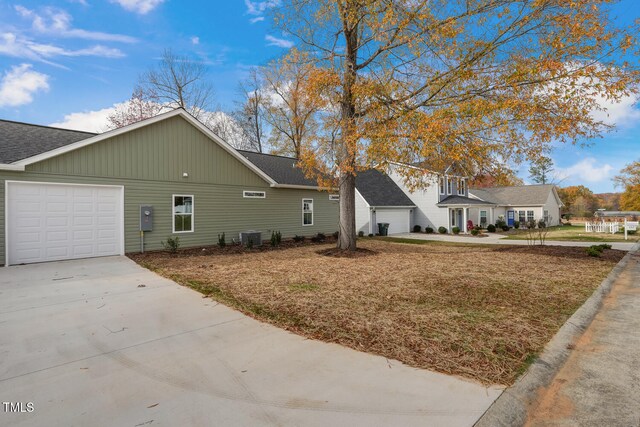 view of property exterior featuring concrete driveway, a shingled roof, an attached garage, and central air condition unit