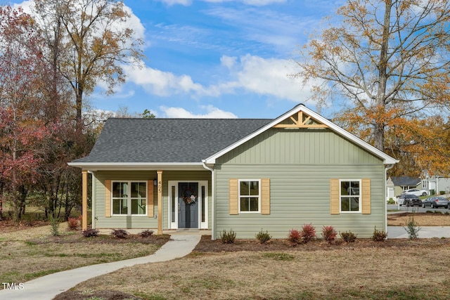 view of front of property featuring a porch and a shingled roof