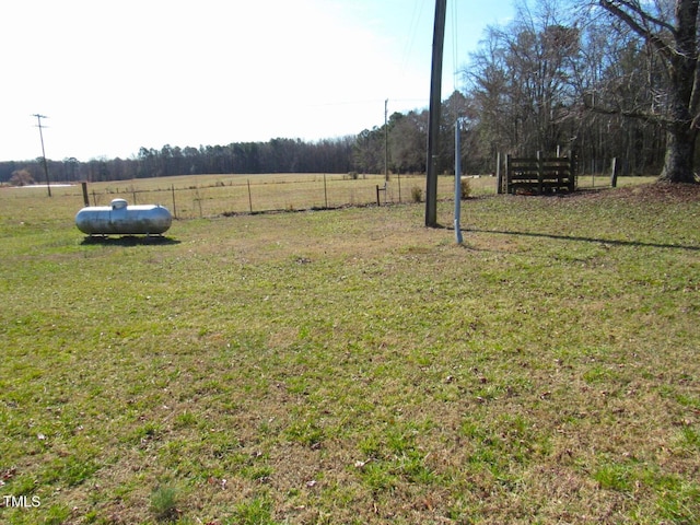 view of yard featuring a rural view and fence