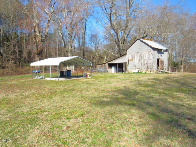 view of yard featuring an outbuilding, a barn, and a detached carport