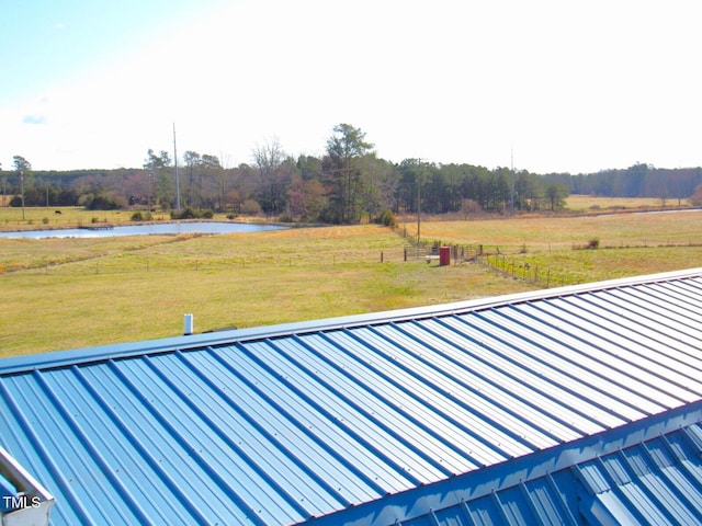 exterior space featuring a water view and fence