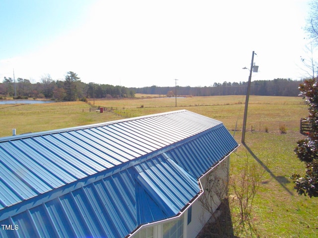 exterior space featuring a water view and a lawn