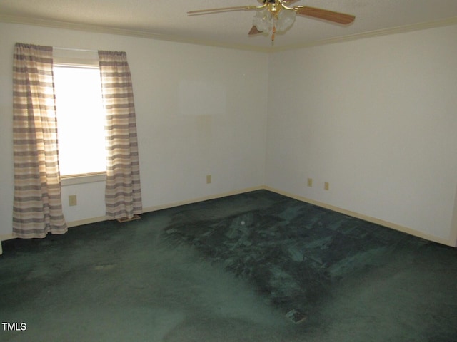 spare room featuring baseboards, ornamental molding, ceiling fan, and carpet flooring