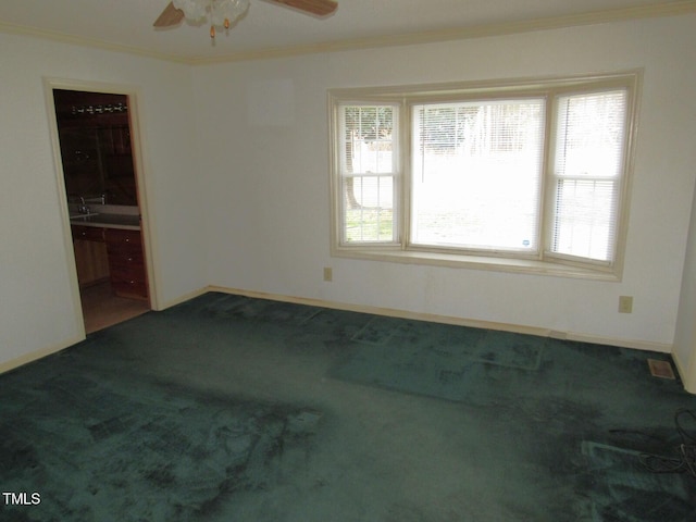 spare room with ornamental molding, carpet flooring, and ceiling fan