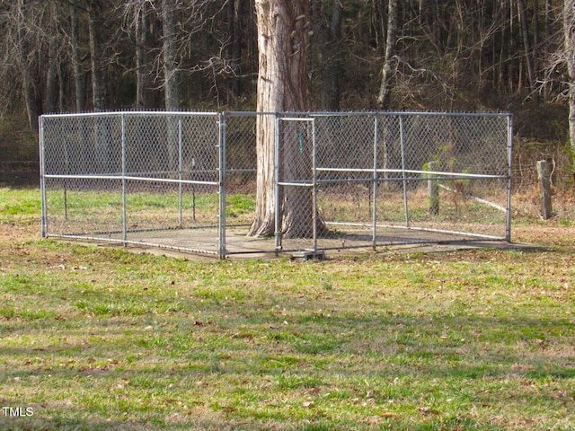 view of property's community featuring a lawn, fence, and a view of trees