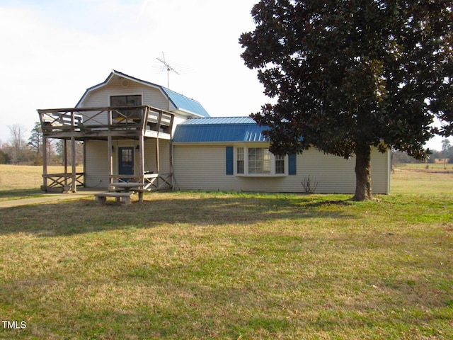 view of front of house with metal roof, a front yard, and a gambrel roof